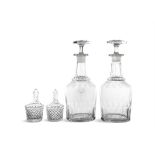 A PAIR OF LATE VICTORIAN GLASS MALLET SHAPED DECANTERS with facet cut decoration and matching