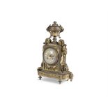 A FRENCH GILT METAL MANTLE CLOCK, LATE 19TH CENTURY surmounted with a classical urn,