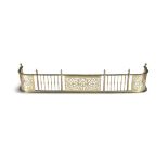 A GEORGE IV PIERCED BRASS CURB FENDER, with spiral reeded top above alternating panels of