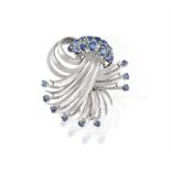 A SAPPHIRE BROOCH, of stylized scrolling design, set with circular-cut sapphires,