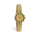 A LADY’S COCKTAIL WATCH WITH DIAMOND AND EMERALD BEZEL BY BUECHE GIROD, of quartz movement,