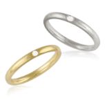 TWO DIAMOND RINGS, BY POMELLATO, each polished gold hoop highlighted with a brilliant-cut diamond