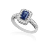 A SAPPHIRE AND DIAMOND RING, the rectangular mount centering a rectangular-cut sapphire,