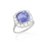 A SAPPHIRE AND DIAMOND RING, set with a cushion-shaped sapphire, to a brilliant-cut diamond