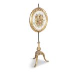 A VICTORIAN GILTWOOD POLE SCREEN with stumpwork oval panel, raised on upright support and