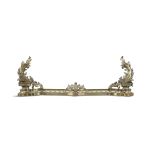 A FRENCH GILT BRASS ADJUSTABLE FENDER, MID 19TH CENTURY the pierced rail mounted with acanthus