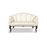A VICTORIAN MAHOGANY FRAMED UPHOLSTERED SETTEE the arched back and armrests covered in a yellow