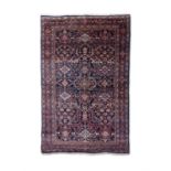 AN ANTIQUE FERAHAN SAROUK WOOL RUG, C.1900-1910, 203 x 130cm with small central medallion on a