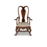 A QUEEN ANNE STYLE WALNUT ELBOW CHAIR, with shaped crest rail above a solid vase splat,