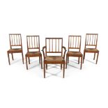 A SET OF FIVE ENGLISH OAK FRAMED STICK BACK DINING CHAIRS WITH DROP-IN RUSH SEATS,