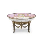 A LATE 19TH CENTURY SEVRES PORCELAIN OVAL DISH, on an ormolu stand, the reserve painted with an