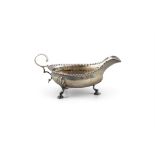 A GEORGE III SILVER OVAL SAUCE BOAT London 1779, of shallow form, with punched rim and double