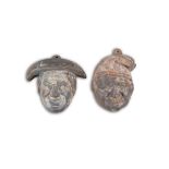 A PAIR OF CAST IRON WALL DECORATIONS IN THE FORM OF FRENCH CHARACTER HEADS each wearing