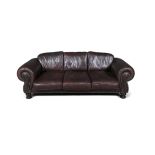 A KUDU LEATHER THREE SEATER SETTEE, with scroll arms, applied close-nail leather studs,