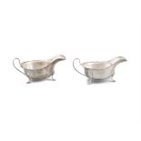 TWO SILVER SAUCEBOATS the scalloped rim and cabriole feet with maker's mark London Sheffield, (6.