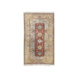A TURKISH CREAM GROUND WOOL CARPET, 207 X 120CM the rectangular centre field woven with five