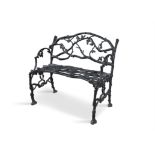 A VICTORIAN CAST IRON BENCH PROBABLY COALBROOKDALE, painted black, cast with oak boughs,.