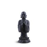 A CHINESE BRONZE FIGURE OF A LOHAN, QING DYNASTY, modelled standing on an inverted lotus pod,