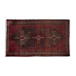 A PERSIAN POSHTHOKI WOOL RUG, 360 x 143CM woven in varying red tones with three interlinked