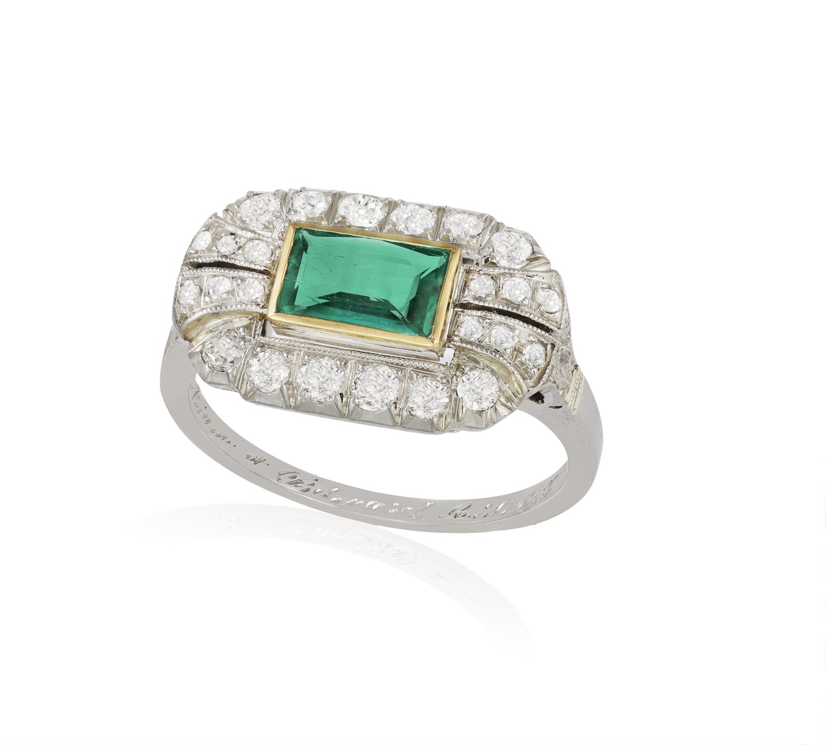 AN EMERALD AND DIAMOND DRESS RING The rectangular-cut emerald within collet-setting,