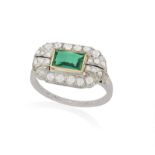 AN EMERALD AND DIAMOND DRESS RING The rectangular-cut emerald within collet-setting,