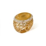 A COCKTAIL 'ARABESQUE' RING, BY POMELLATO The oval-shaped orangy-yellow (amber or citrine)