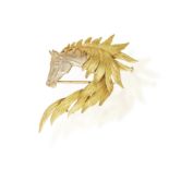 A GOLD NOVELTY BROOCH, BY HERMÈS, CIRCA 1965 Modelled as the head of a horse in brushed gold,