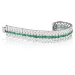 A FINE ART DECO EMERALD AND DIAMOND BRACELET, CIRCA 1935 Of openwork design, the continuous line