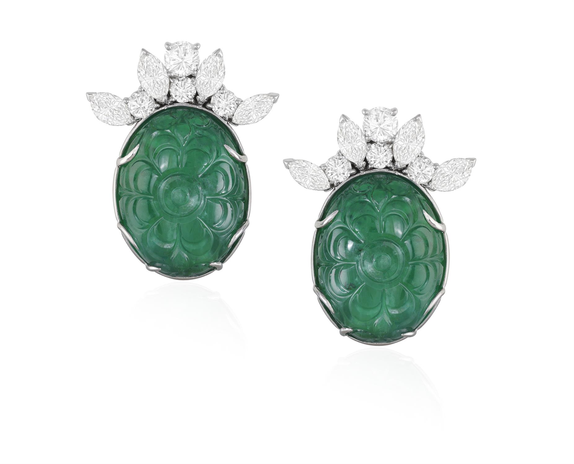 A PAIR OF EMERALD AND DIAMOND EARCLIPS Each oval-shaped carved emerald with foliate detailing