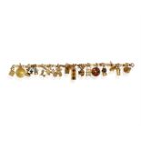 A GOLD CHARM BRACELET The fancy-link chain suspending eighteen charms including an umbrella,