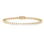 A DIAMOND LINE BRACELET The continuous line of brilliant-cut diamond within claw-setting,