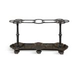 A VICTORIAN BLACK PAINTED CAST IRON STICK STAND, 19th century the nine-compartment top with three