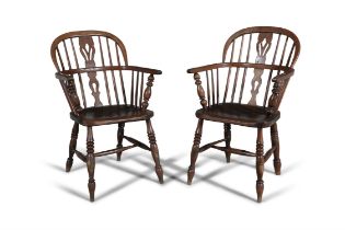 A PAIR OF STAINED ELM WINDSOR ARMCHAIRS, 19TH CENTURY with arched stick-backs and solid seats, on