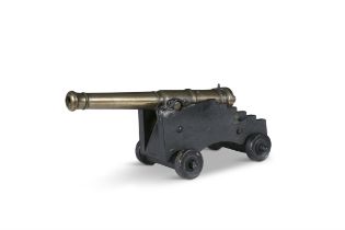 AN EARLY 19TH CENTURY BRONZE SIGNAL CANNON, on ebonised timber carriage, the five-stage detachable