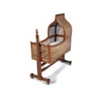 A MAHOGANY AND CANEWOOK CHILD'S CRADLE, 19TH CENTURY with arched hood and slatted timber base, on