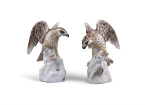 A PAIR OF EARLY 20TH CENTURY GERMAN PORCELAIN MODELS OF EAGLES each with wings outstretched whilst