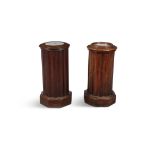 A PAIR OF EARLY VICTORIAN MAHOGANY AND MARBLE TOPPED POT CUPBOARDS, of fluted cylindrical form,