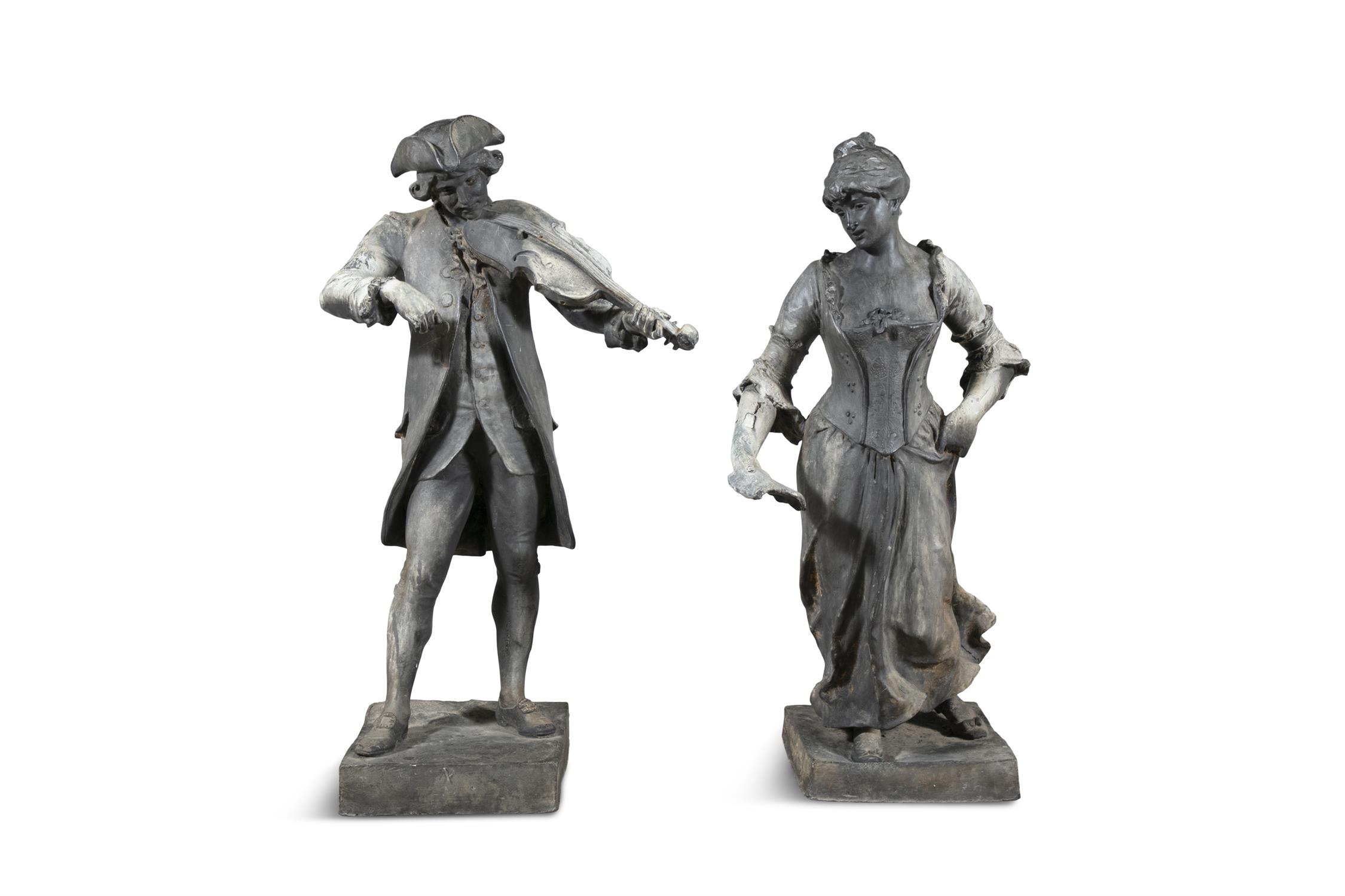 A PAIR OF FRENCH 19TH CENTURY LEAD STANDING FIGURES OF A YOUNG MAN WITH VIOLIN AND DANCING WOMAN