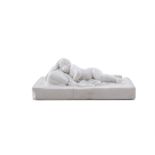 A FIGURE OF A SLEEPING PUTTO, IN THE MANNER OF FRANCOIS DUQUESNOY, on rectangular base. 14cm wide