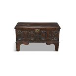 A SMALL 17TH CENTURY CARVED OAK COFFER, the two plank hinged above a carved front with initials 'M