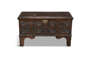 A SMALL 17TH CENTURY CARVED OAK COFFER, the two plank hinged above a carved front with initials 'M