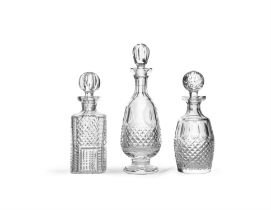 A COLLECTION OF THREE GLASS DECANTERS, two of mallet from, the other of baluster form, each with