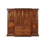 A FLAME MAHOGANY BREAKFRONT CABINET, the moulded cornice above central panelled doors, above two