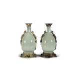 A PAIR OF CHINESE CELADON GLAZED BOTTLE VASES WITH EUROPEAN MOUNTS, the handles formed as dragons.