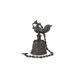 A BRONZE CINGALESE BELL, with mythological bird handle, the body cast with tendrils, flowerheads and
