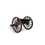 A 19TH CENTURY CAST IRON CANON on a wheel carriage, together with a stand containing gunners ramrods