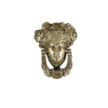 A GEORGIAN STYLE BRASS DOOR KNOCKER, in the form of a Classical female head with swag knocker. 18