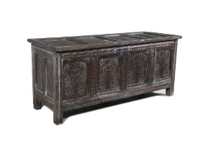 A CHARLES II CENTURY CARVED OAK COFFER, C.1680 with hinged cover and panelled sides decorated with