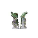 A PAIR OF 19TH CENTURY SAMSON OF PARIS PAINTED PORCELAIN MODELS OF GREEN PARROTS standing on tree