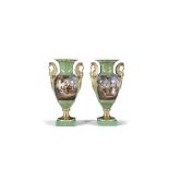 A PAIR OF 19TH CENTURY CONTINENTAL PORCELAIN BALUSTER VASES, decorated in green and gilt with hand